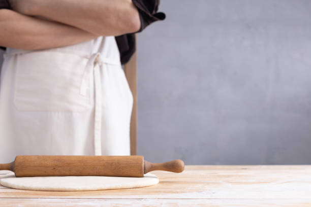 istock Baker man kneading or making dough and bakery ingredients for homemade bread cooking on shelf. Bakery concept 1309386257