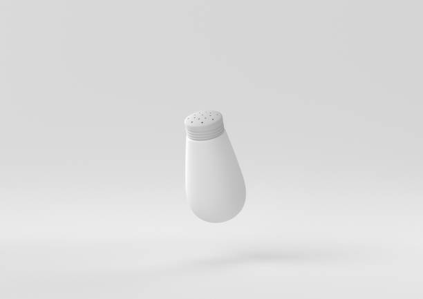 overturned salt shaker with salt on the side representing excess consumption