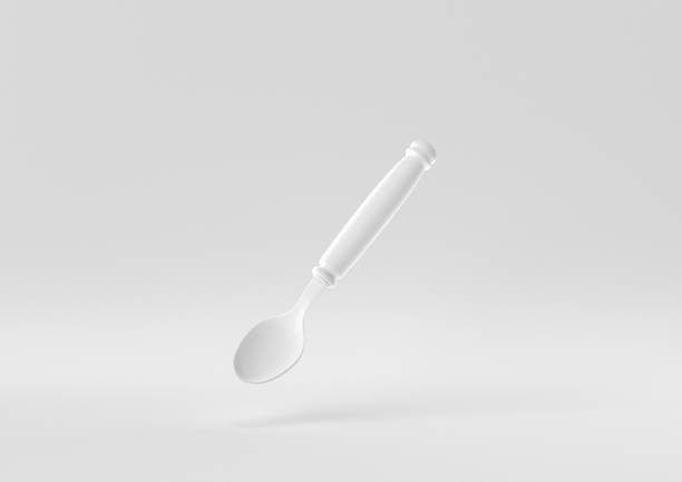 istock White spoon floating in white background. minimal concept idea creative. monochrome. 3D render. 1309387057