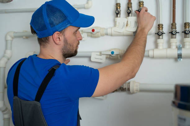 istock Uniformed plumber is at work - closing and opening the taps 1309387251
