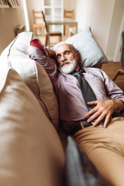 istock mature adult sleeping in the couch 1309390543