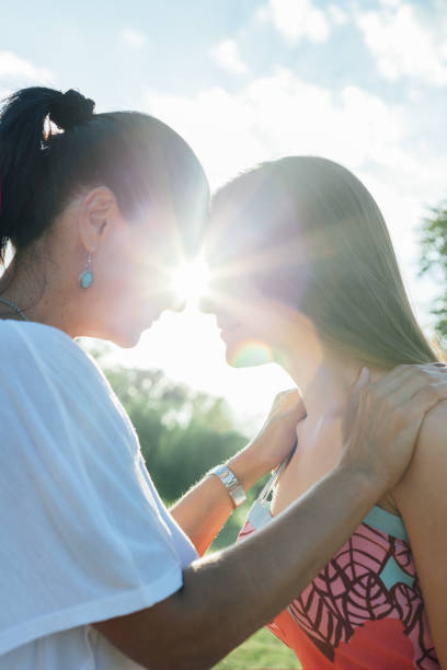 istock Daughter With Mother Hugging At Sunset 1309391342