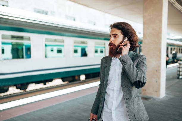 istock hipster ready to leave with backpack at station on the phone 1309391446