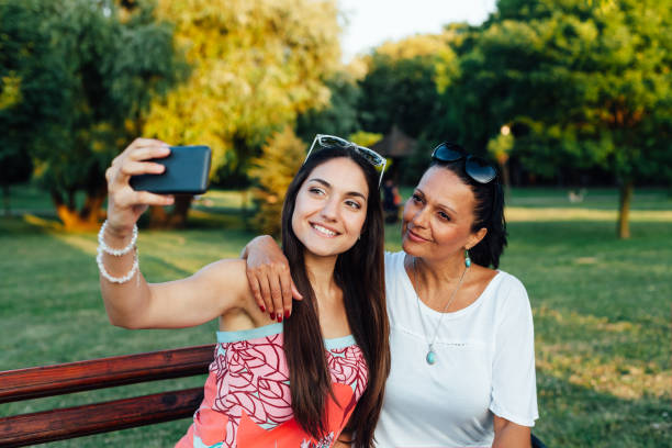 istock Mother And Daughter Women Using A Mobile Phone 1309392204
