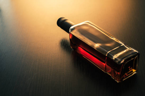 alcoholic drink, bottle of whiskey on wooden background