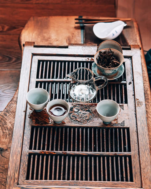 istock Table with ceramic white cups and glass teapot for Chinese tea ceremony 1309393156