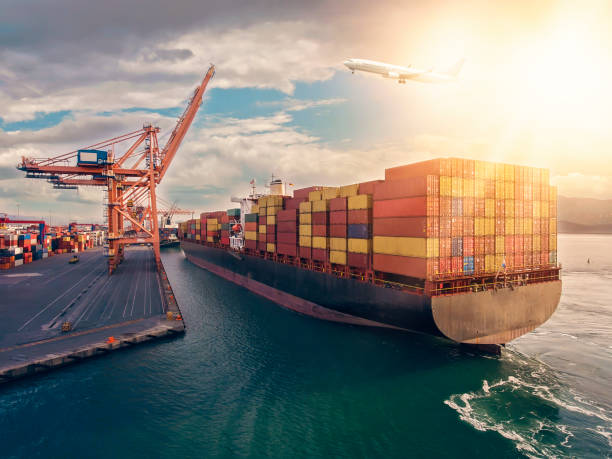istock Airplane flying over the container port. 1309395839