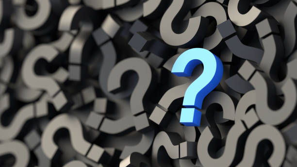 istock Blue question mark on a background of black signs, FAQ Concept 1309398082