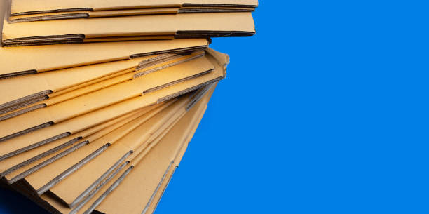 istock Stacking of cardboard boxes, Corrugated paper on blue background. 1309401235