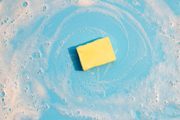 istock Dishwashing sponge with foam on blue background. 1309401366