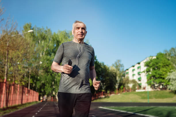 istock Senior seventy years old man jogging at sunrise 1309402022
