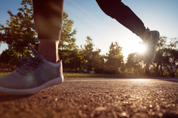istock Runner feet running on road closeup on shoe 1309402040