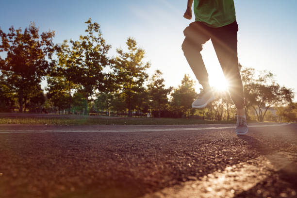 istock Runner feet running on road closeup on shoe 1309402124