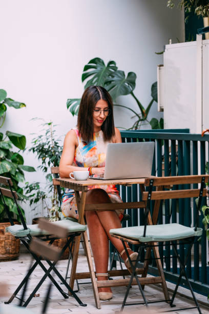 istock Freelance Woman Doing Her Work in Cafe 1309403916