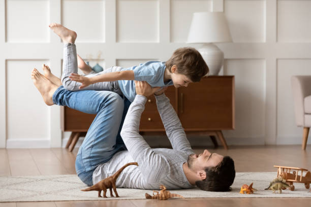 istock Overjoyed loving father playing active game with adorable son 1309403961
