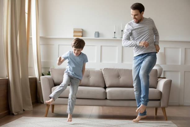 istock Happy father and little son dancing, having fun at home 1309403992