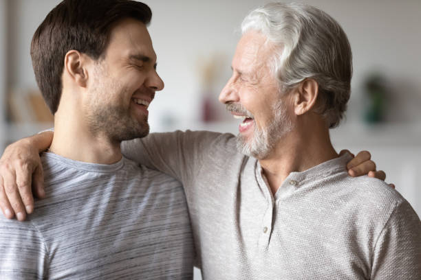 istock Close up overjoyed mature father with son laughing, having fun 1309404536