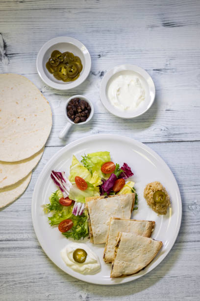istock chicken quesadilla with rice, beans, salad, chalapenos and salsa 1309405948
