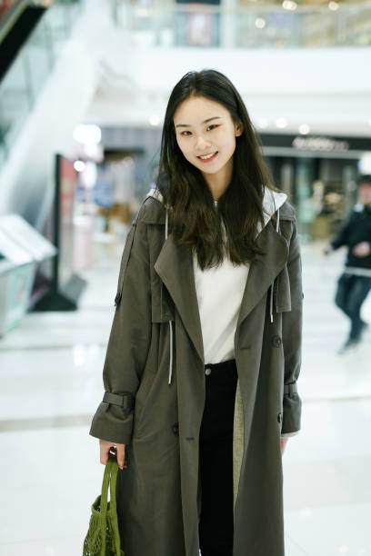 istock Young Asian in the mall, looking at the camera and smiling 1309406891