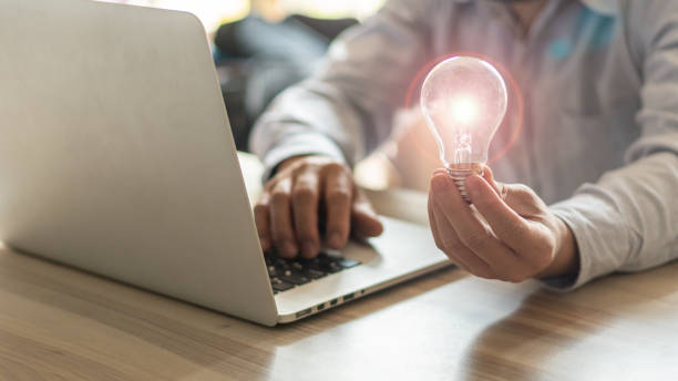 istock The businessman's hand holds a light bulb. Innovative ideas and inspiration for work 1309407034