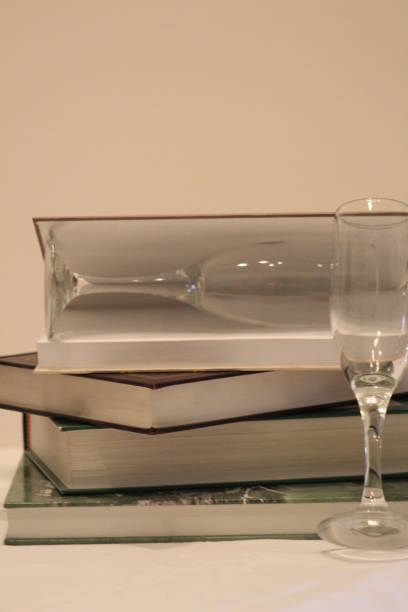 istock BOOKS AND GLASSES OF CHAMPAGNE. 1309407280