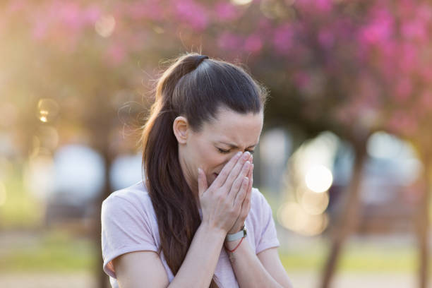 istock Young girl having allergy reaction on blooming tree in spring 1309408172