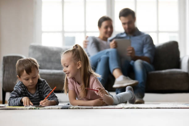 istock Happy cute preschooler kids lying on heating floor 1309409439
