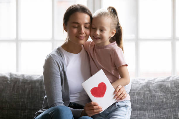 istock Happy grateful mom holding greeting card with drawn heart 1309409459