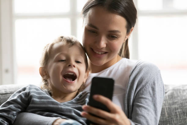 istock Happy mom and excited cute son kid speaking and smiling 1309409472
