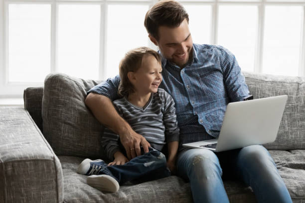 istock Happy daddy and adorable gen Z boy sitting together 1309409476