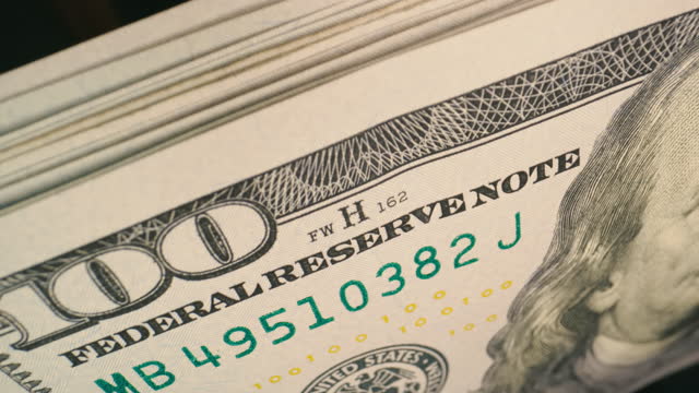 100 dollar bills being counted, stacking. USD Notes. Cinematic look