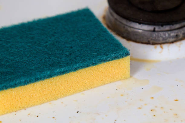 istock A cleaning sponge lies on a dirty kitchen stove 1309410449