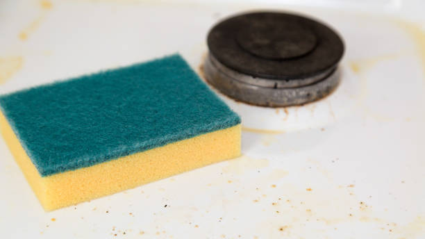 istock A cleaning sponge lies on a dirty kitchen stove 1309410458