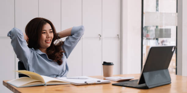 istock Smiling asian woman using laptop computer at office. 1309411538