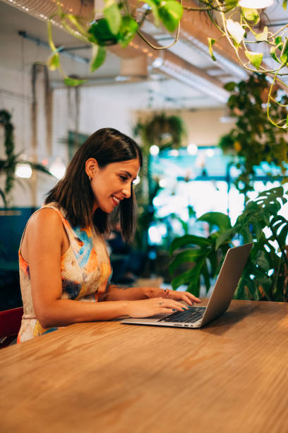 istock Urban Woman Working at the Computer in Cafe 1309417389