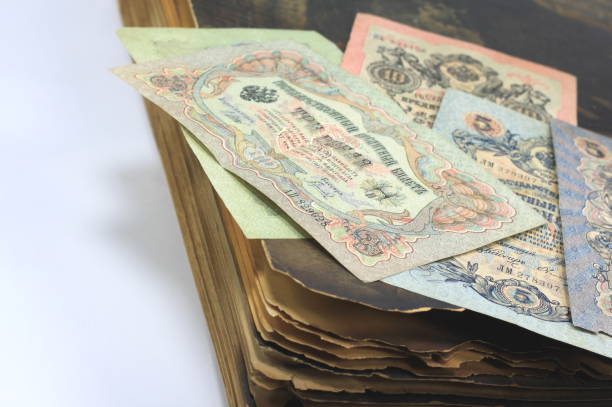 istock vintage antique paper money on old antique book 1309419607