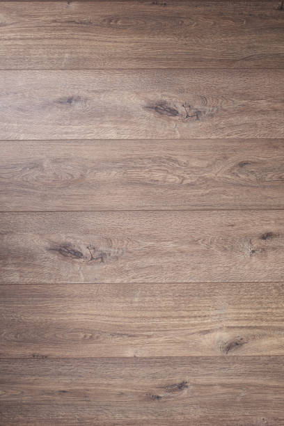 istock Laminated wooden floor background texture.  Brown wood laminate floor 1309419987