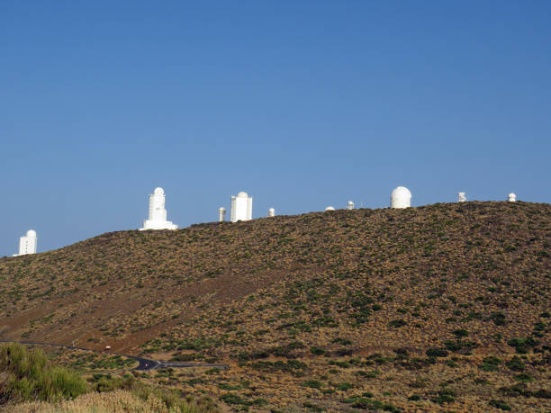 Profile of white telescopes under blue sky. Teide Astrophysical Observatory. Observational set of the Institute of Astrophysics. Architecture pattern. Universe, research concept.