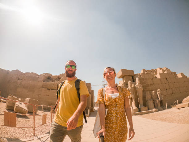 istock Couple travel in Egypt, take selfie with ancient temple 1309420906