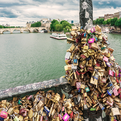 Love padlocks on the bridge Pont des Arts across river Seine in Paris, France.