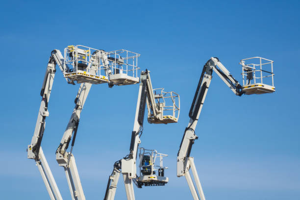 istock Telescopic boom lift against blue sky. Cherry pickers 1309423365