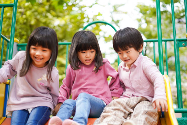 istock Small children playing on the slide 1309423386