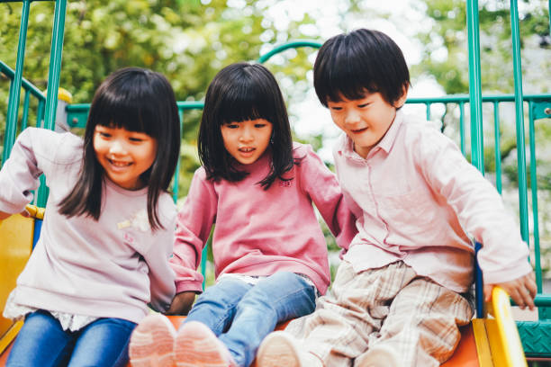 istock Small children playing on the slide 1309423388