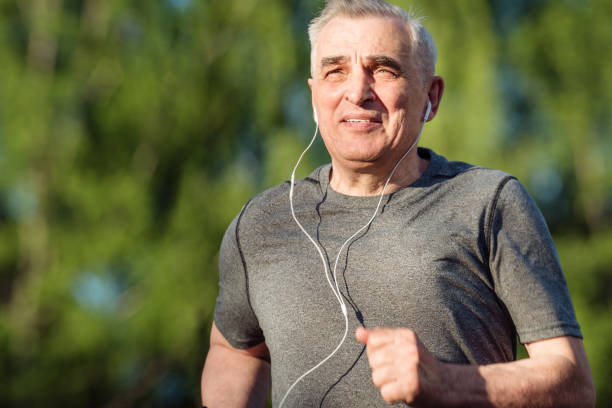 istock Senior seventy years old man jogging at sunrise 1309423599