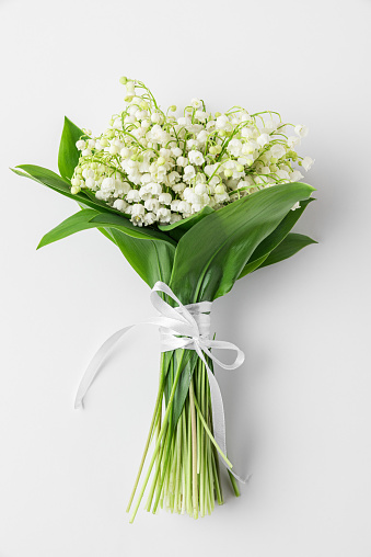 Lily of the valley flowers isolated on white background. Womens Day, Mothers Day, Wedding concept. Spring bouquet. flat lay, top view. vertical orientation
