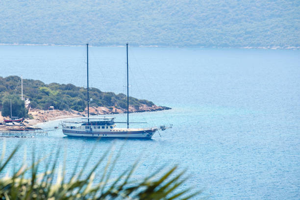 istock Turquoise sea and sailboat moored. Summer vacation concept. 1309428241
