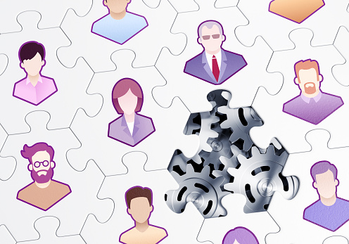 Composed together hexagonal pieces of a jigsaw puzzle with pictured pictograms of office staff persons and one of them is missing. 3D-rendering graphics on the theme of Business Management.
