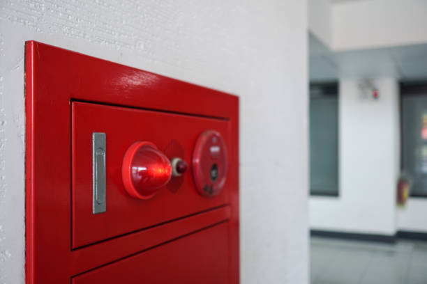istock Close-up on fire fighting equipment in modern building. The fire hydrant is on the left side of the photo. The blurred background is a fire extinguisher. 1309429667