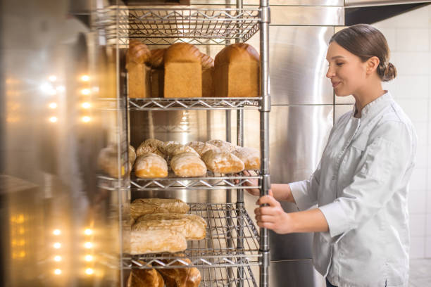 istock Happy woman looking at freshly baked bread 1309431271