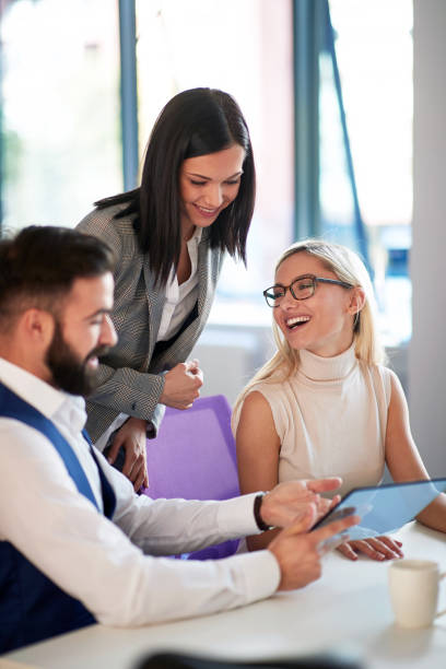 istock Office colleagues smiling while discussing business 1309432344
